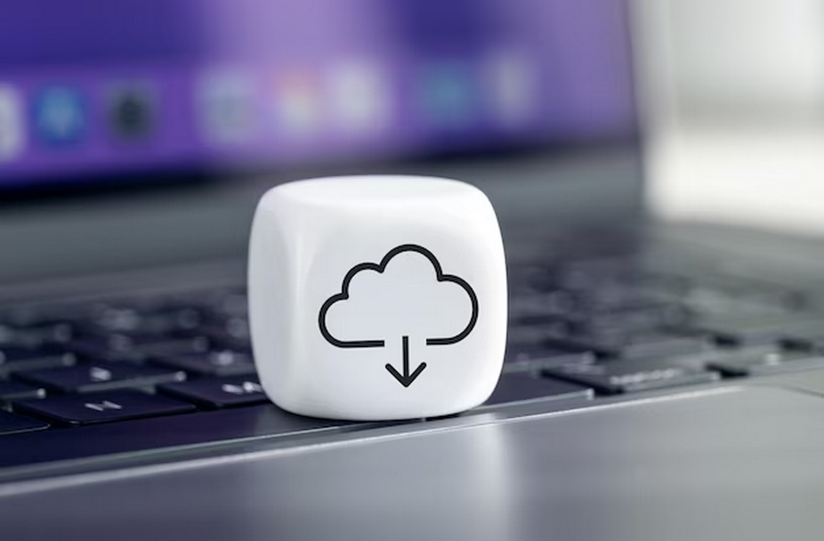 White cube with cloud icon atop laptop keyboard.