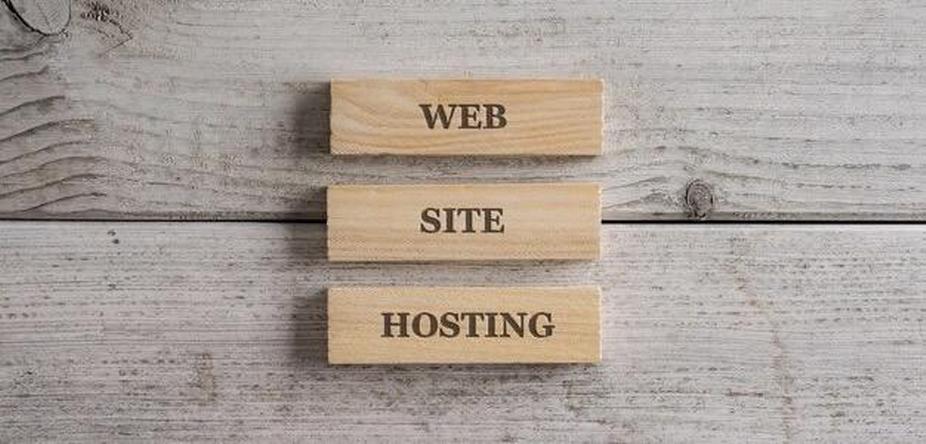 Three wooden blocks with the inscription website hosting